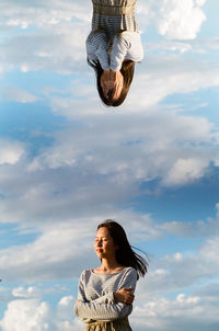 Low angle view of woman against sky