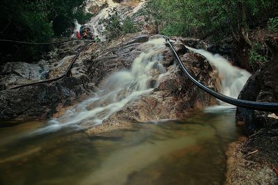 Water flowing through rocks in forest