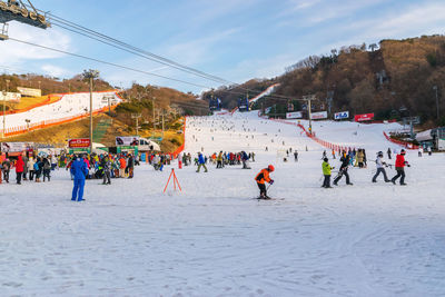 Crowd on snow covered land