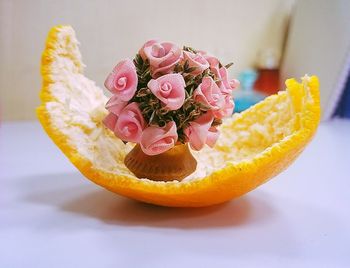 Close-up of pink rose on table