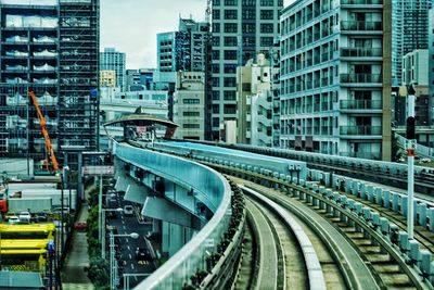 High angle view of railroad tracks amidst buildings in city