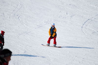 Rear view of people skiing in snow