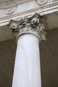 Low angle view of statue against white wall