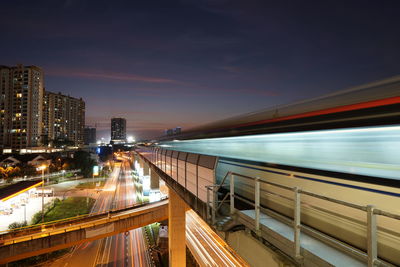 Blurred motion of train in illuminated city at night