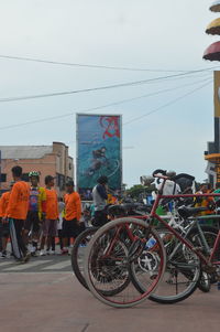 People on street in city against sky