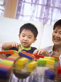 Grandmother playing with grandson at home