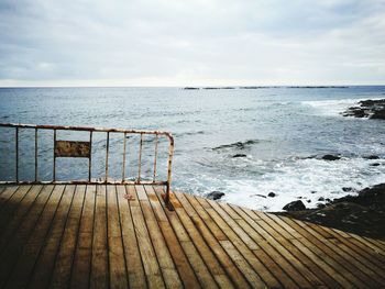Pier over sea against sky