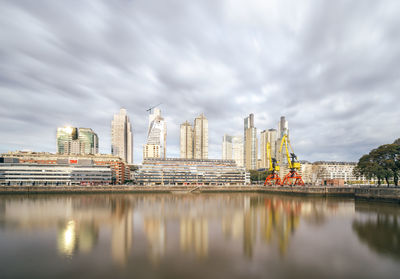 Bridge over river with buildings in background