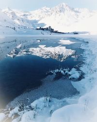 Aerial view of snow covered mountains against sky