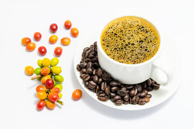 High angle view of coffee beans against white background