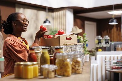 Side view of man preparing food at home