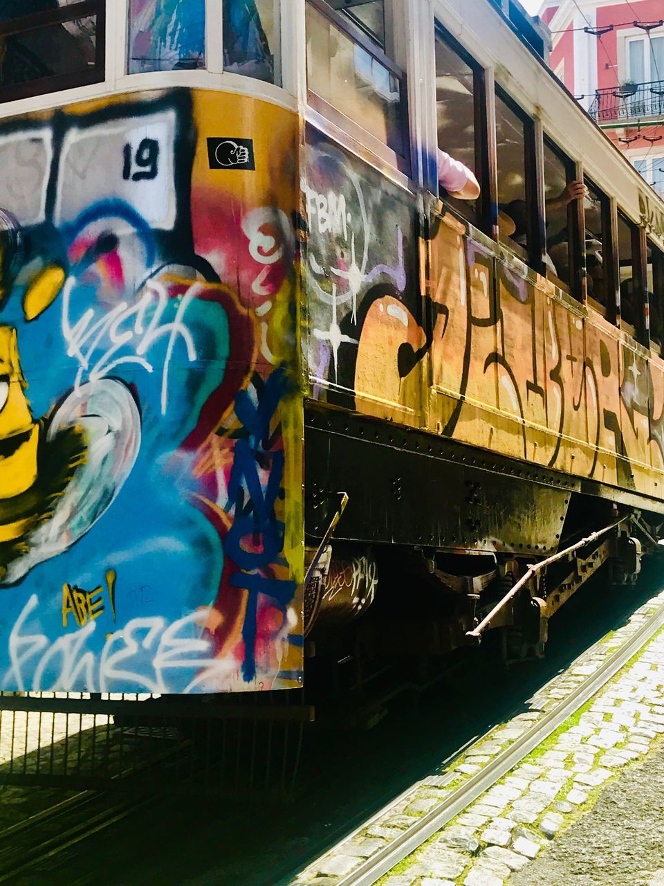 GRAFFITI ON TRAIN AT RAILROAD TRACKS