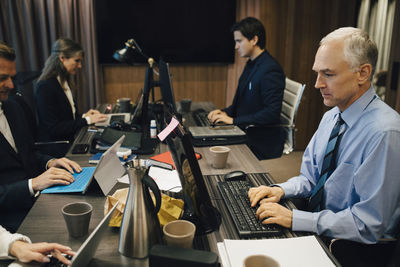 Business people working in board room at office