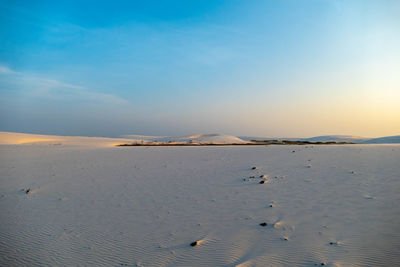 Scenic view of land against sky during sunset