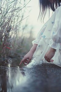 Side view of woman sitting in water