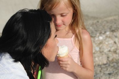 Close-up of woman holding girl with face