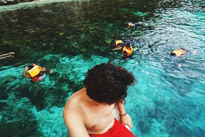 High angle view of friends swimming in pool