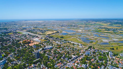 High angle view of town against clear blue sky