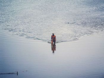 High angle view of man walking in sea