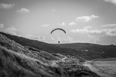 Scenic view of landscape against sky paragliding 