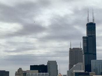 Modern buildings in city against sky