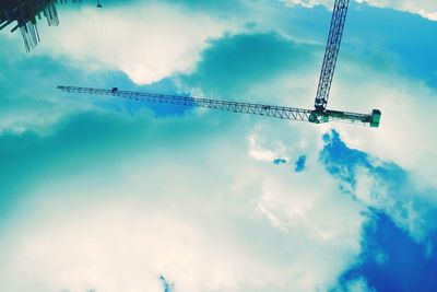 Low angle view of crane against sky