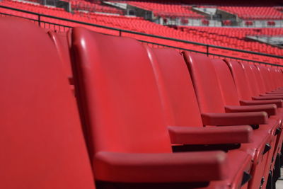 Full frame shot of empty red chairs in stadium