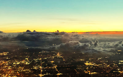 Aerial view of landscape against dramatic sky during sunset