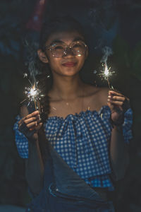 Young woman with burning candle