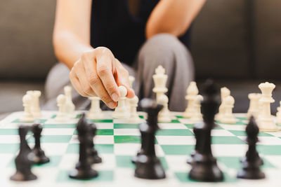 Midsection of woman playing chess