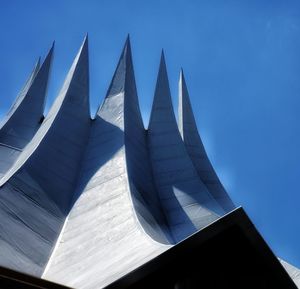 Low angle view of modern building against clear blue sky