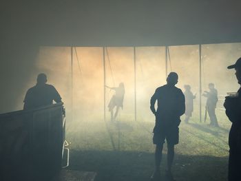 People enjoying amidst smoke at party