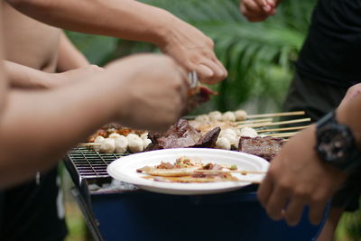 Midsection of people having food