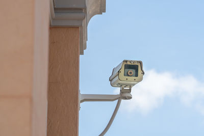 Low angle view of telephone pole against sky