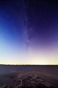 Scenic view of landscape against clear sky at night