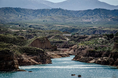 Scenic view of river amidst mountains