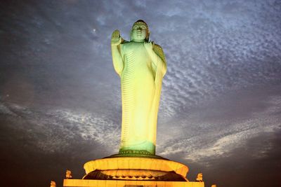 Low angle view of statue against illuminated sky