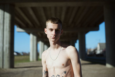 Portrait of shirtless young man outdoors