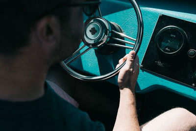 Close-up of hand holding motorcycle