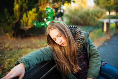 Portrait of young woman sitting outdoors