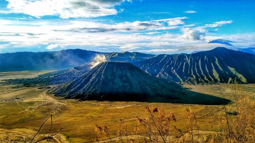 Panoramic view of volcanic landscape against cloudy sky