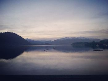 Scenic view of lake against cloudy sky