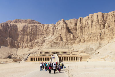 Tourists walking towards temple of hatshepsut