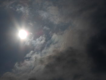 Low angle view of sun shining in sky