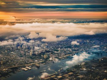 Cityscape and river against sky