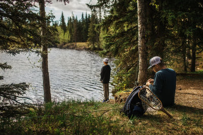 Father preparing fishing line on father/son fishing trip