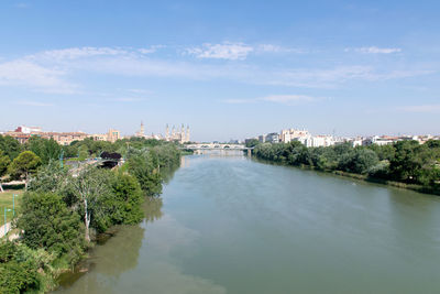 River amidst buildings against sky