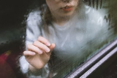 Close-up of woman holding wet glass