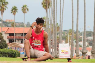 Full length of man sitting outdoors