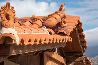 Sculpture of building against cloudy sky